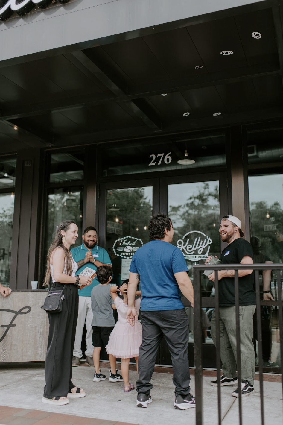 People connecting outside a downtown Winter Garden storefront